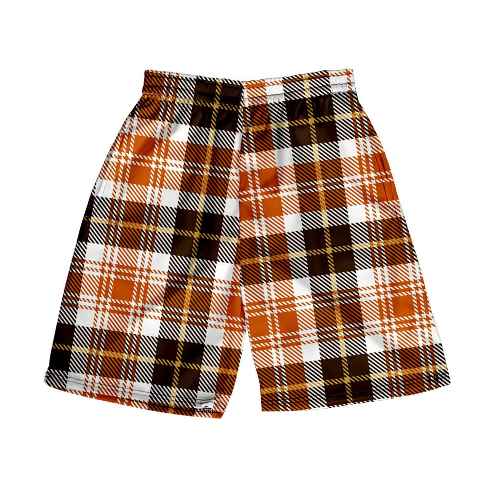 Man wearing grey plaid casual shorts with an elastic waistband, on a beach.