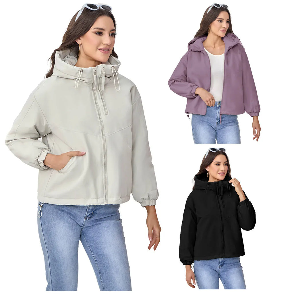 Women's loose-fit hooded shell jacket in grey shown from the front, with long sleeves and a zip front.