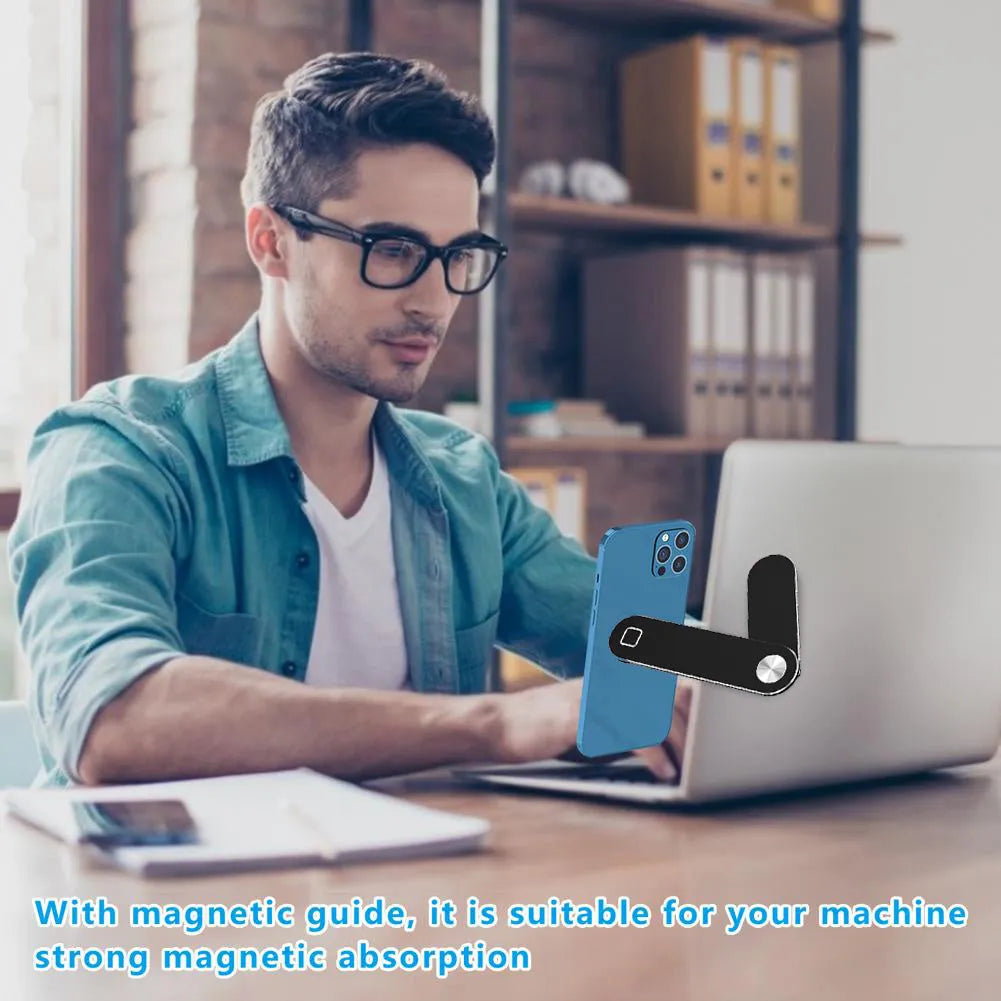 Black aluminium laptop phone holder with magnetic bracket mounted on a monitor, showing a smartphone attached for dual-screen use