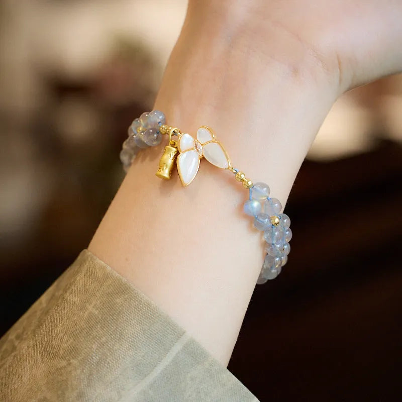 Grey moonstone bracelet with butterfly weave pattern on woven cord