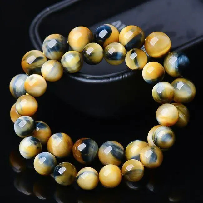 Handmade fantasy tiger eye agate beaded bracelet with 10mm round beads on a wrist.