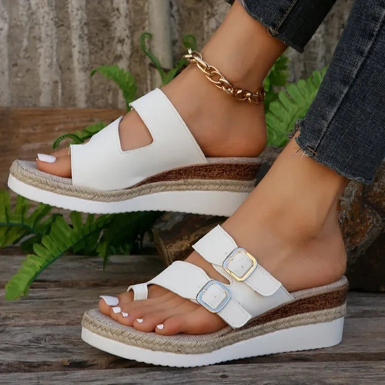 White patent leather women's wedge sandals with finger-fit woven design and peep toe.
