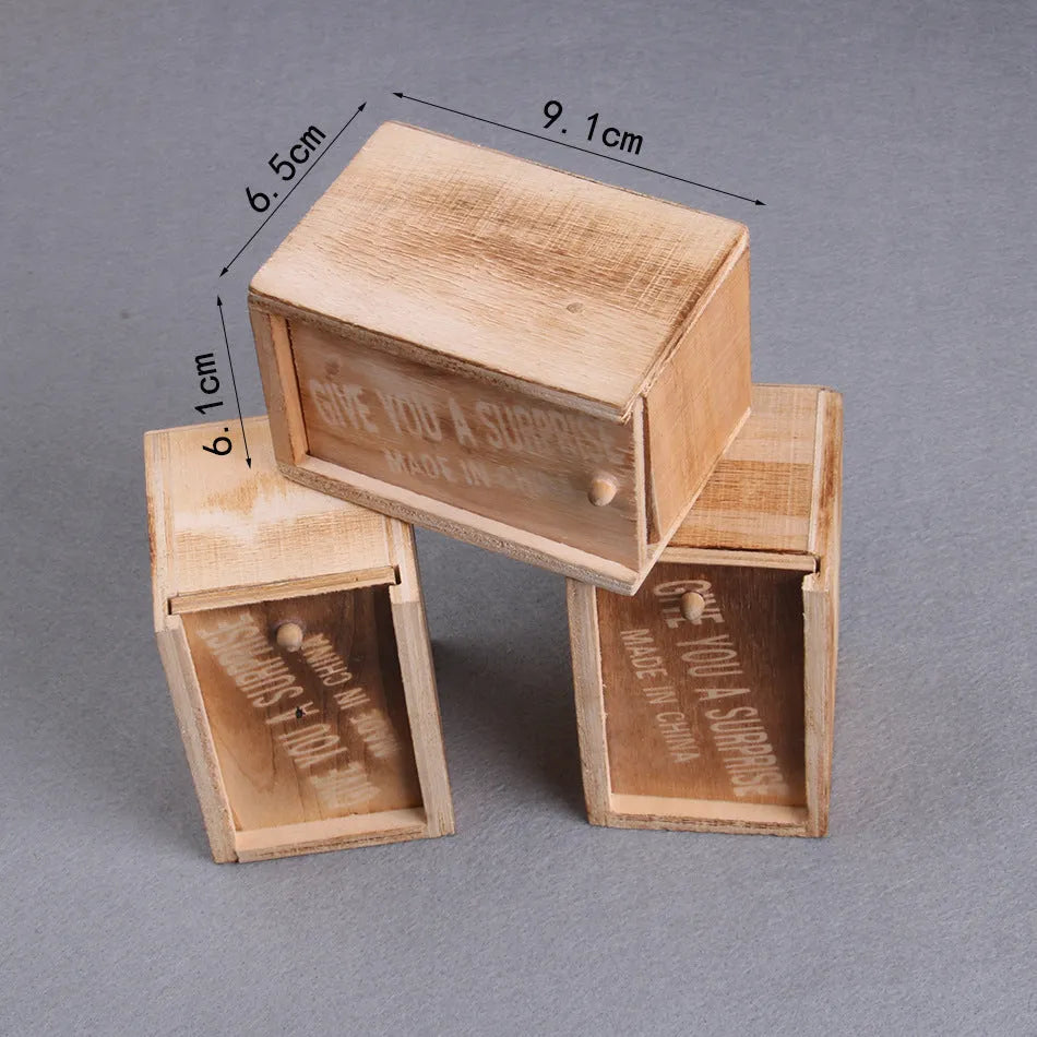 Wooden prank scare box closed, dimensions 9.1cm x 6.1cm x 6.5cm, for April Fools' jokes.