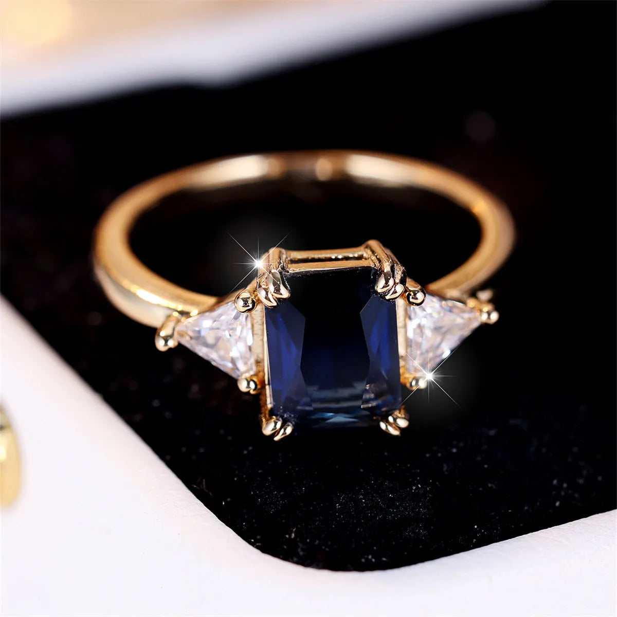 Gold sapphire blue rectangular copper ring for women showing geometric shape and metallic finish