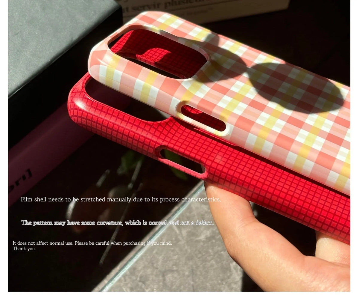 iPhone 15 Pro Max case with red and orange plaid pattern in glossy and frosted finishes