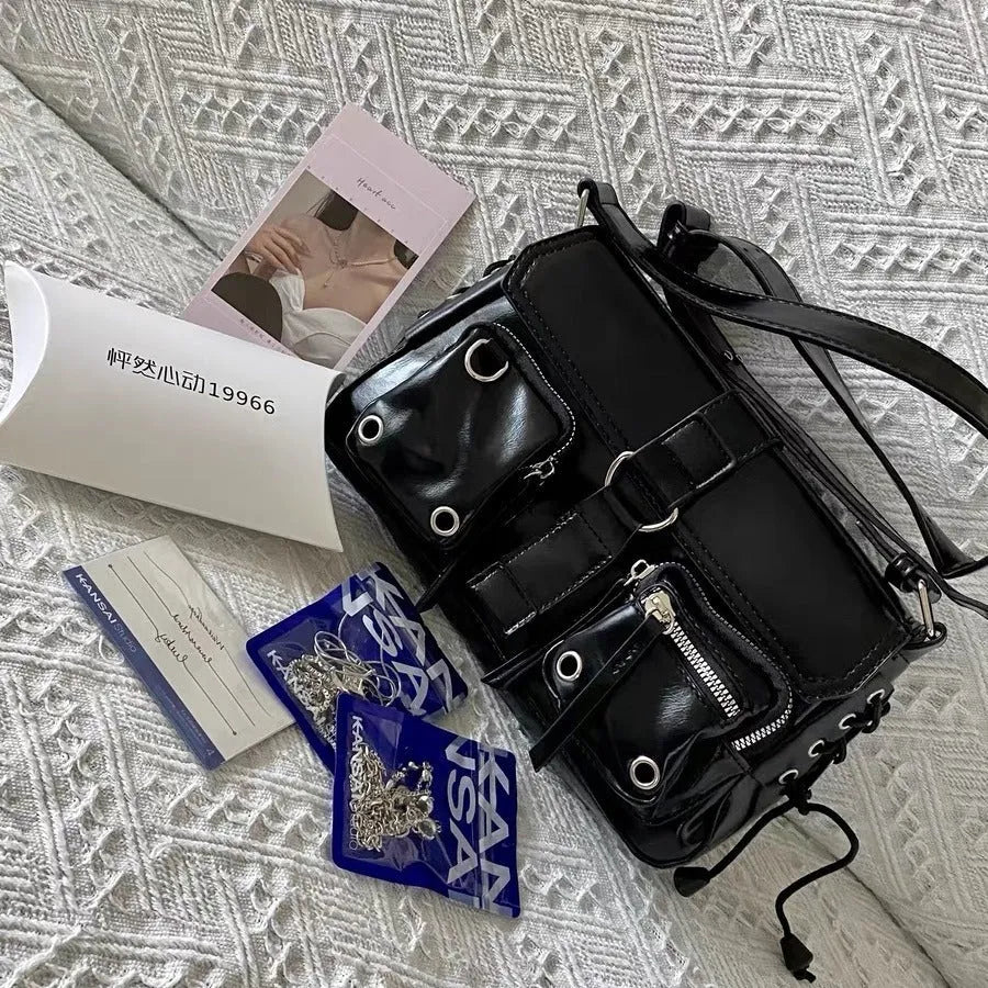 Black PU messenger bag with adjustable strap, showing compact 16cm height and 27cm width dimensions