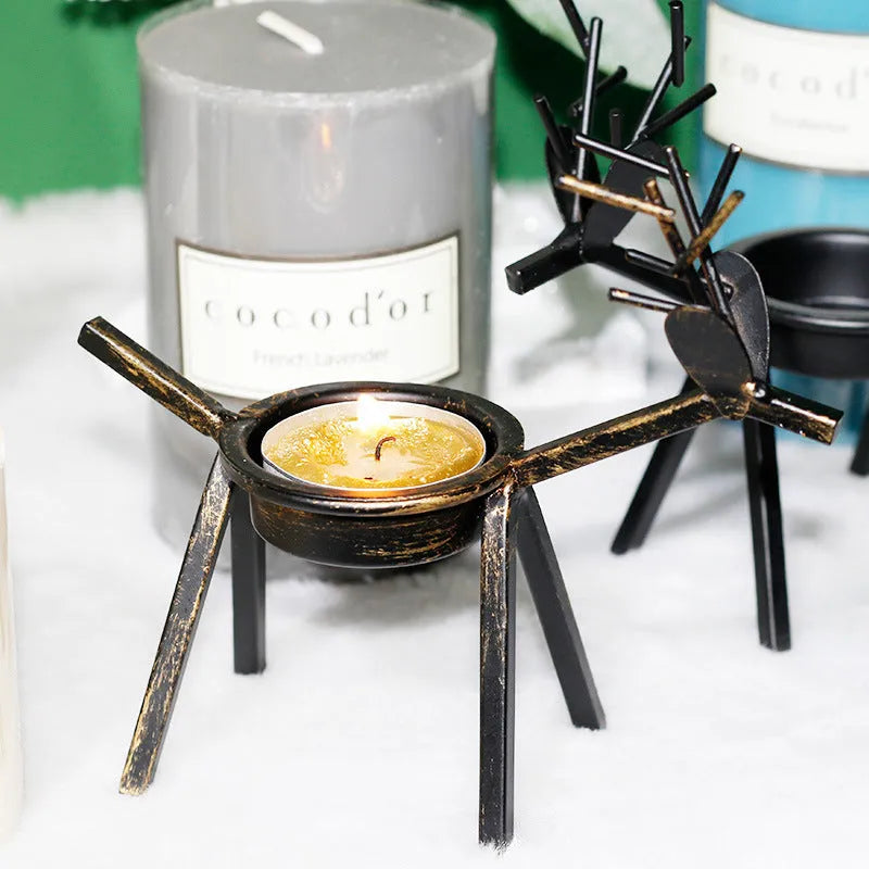 Black iron Christmas deer candlestick holder with Santa and snowman designs, 15cm height