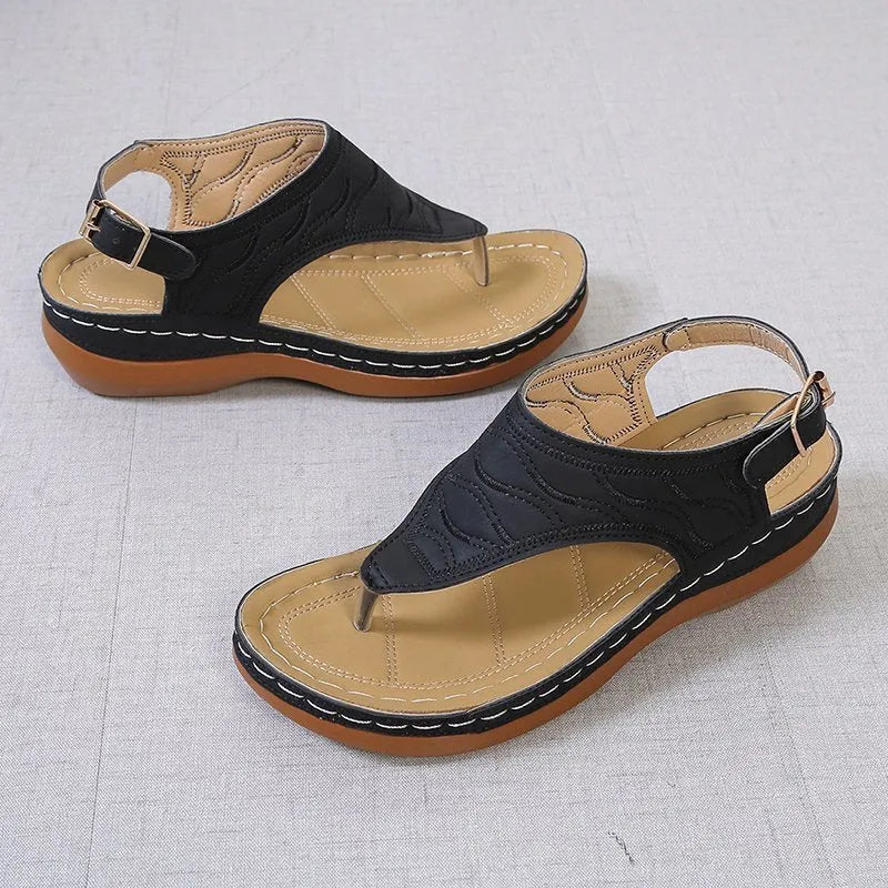 Women's casual wedge heel flip flop sandals with an adjustable buckle strap on the back, shown in a solid colour.