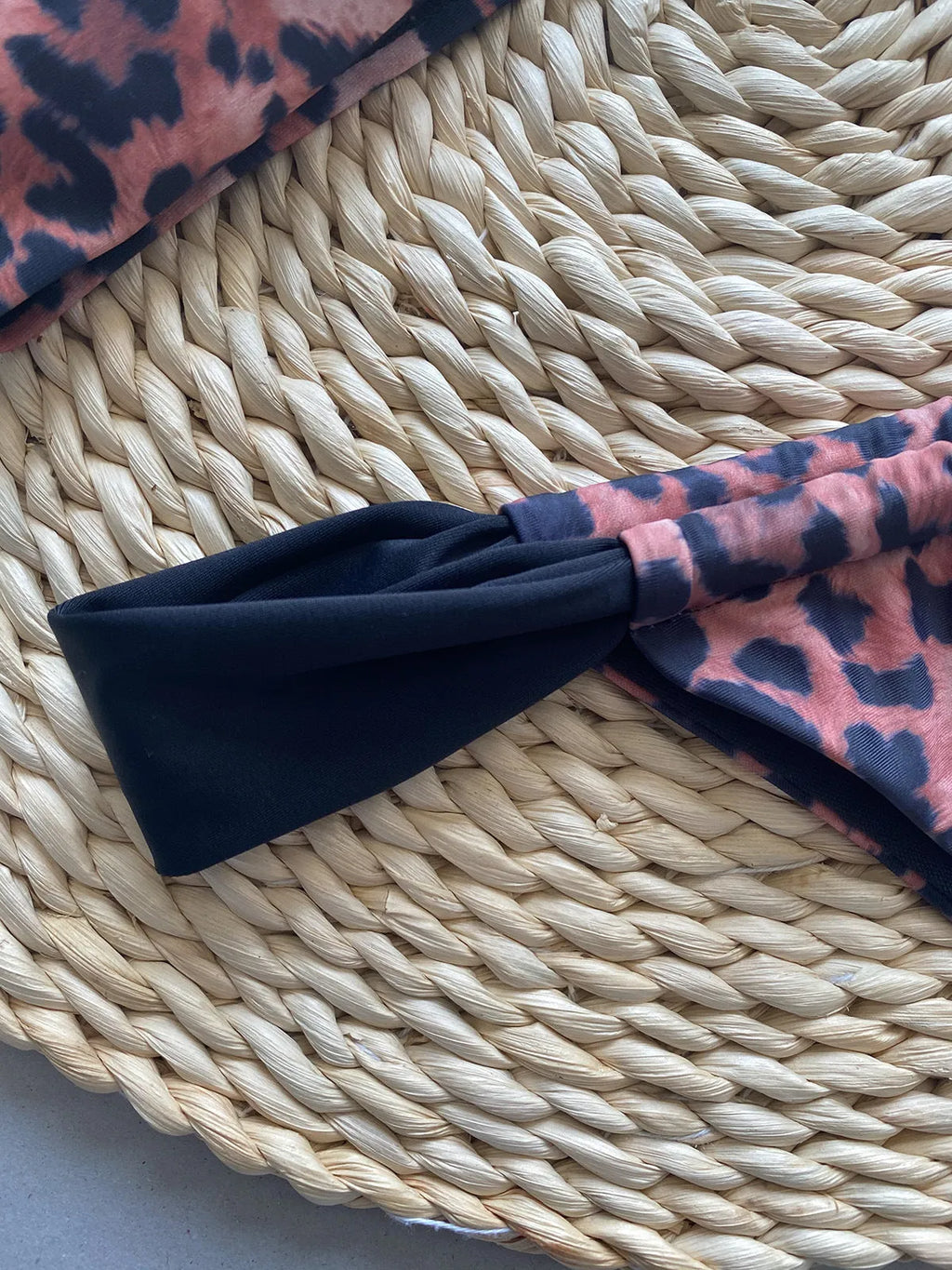 Women's leopard print bikini set with black split tube top and matching bottoms