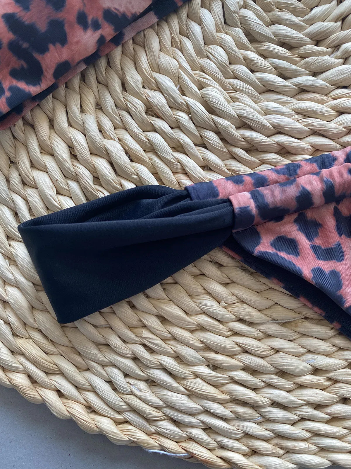 Women's leopard print bikini set with black split tube top and matching bottoms