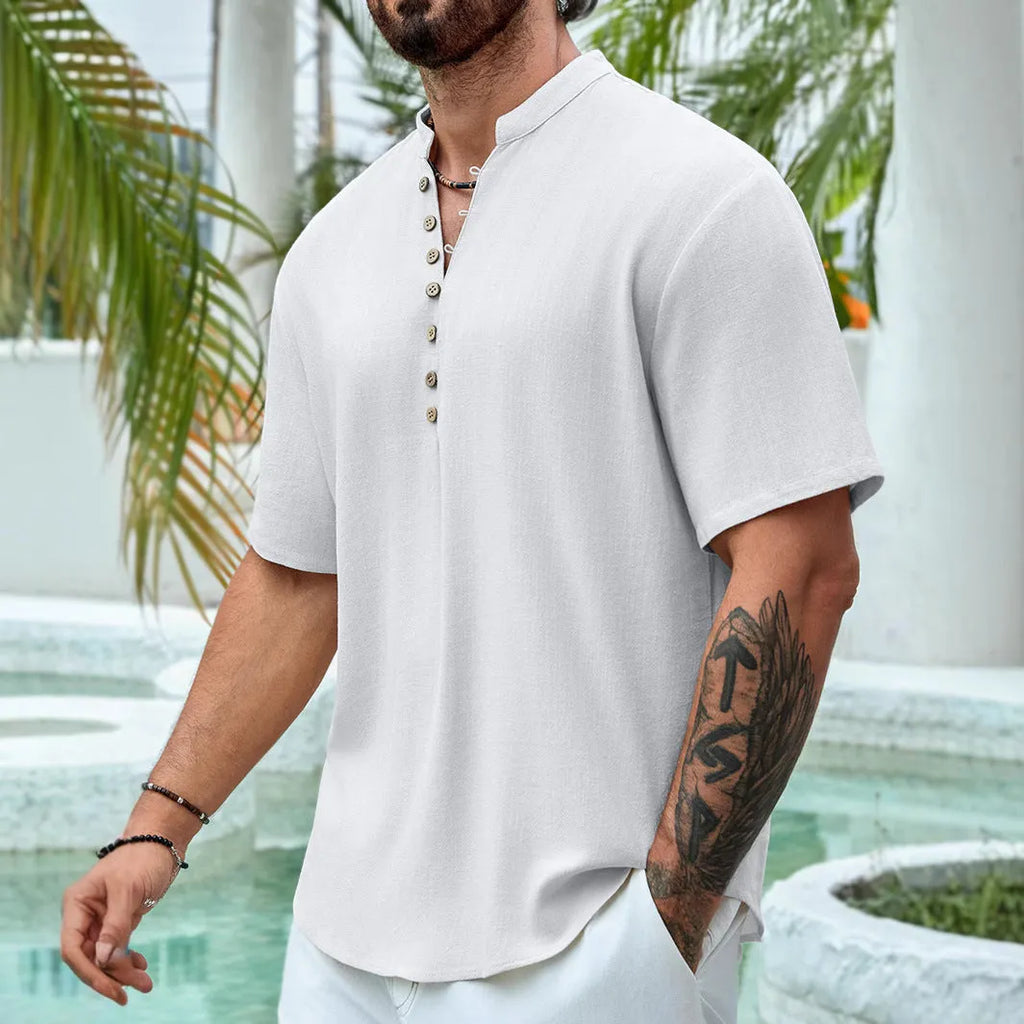 Man wearing a deep V-neck short sleeve casual shirt in a solid colour.