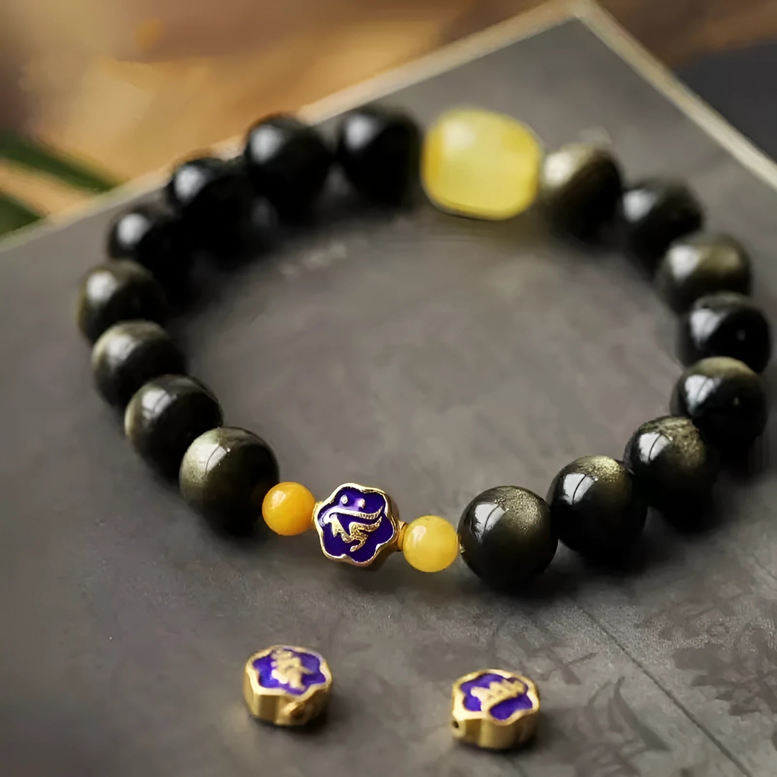 Golden obsidian bracelet with hand-carved Chinese zodiac animal beads in geometric shapes