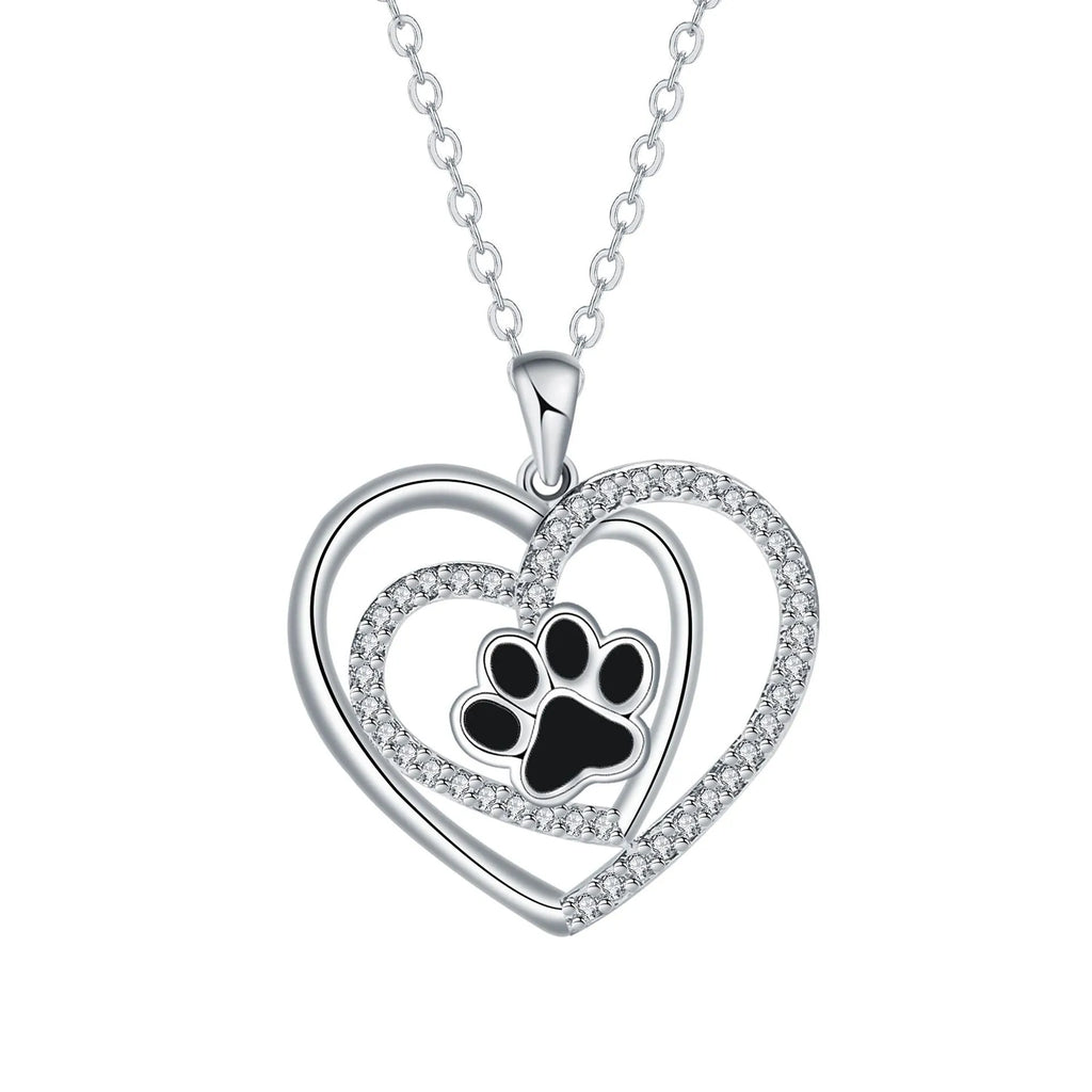 Women's copper necklace with dog paw and heart pendant on a cross chain.