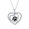Women's copper necklace with dog paw and heart pendant on a cross chain.