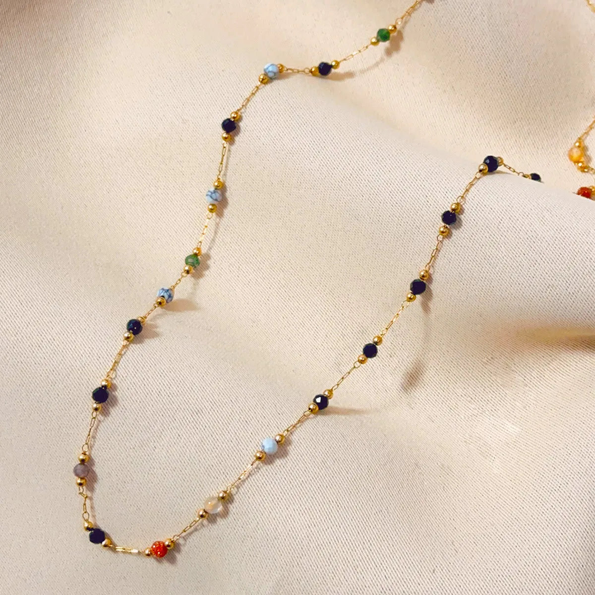 Women's gold titanium steel necklace with a simple natural stone pendant on an O-ring chain.