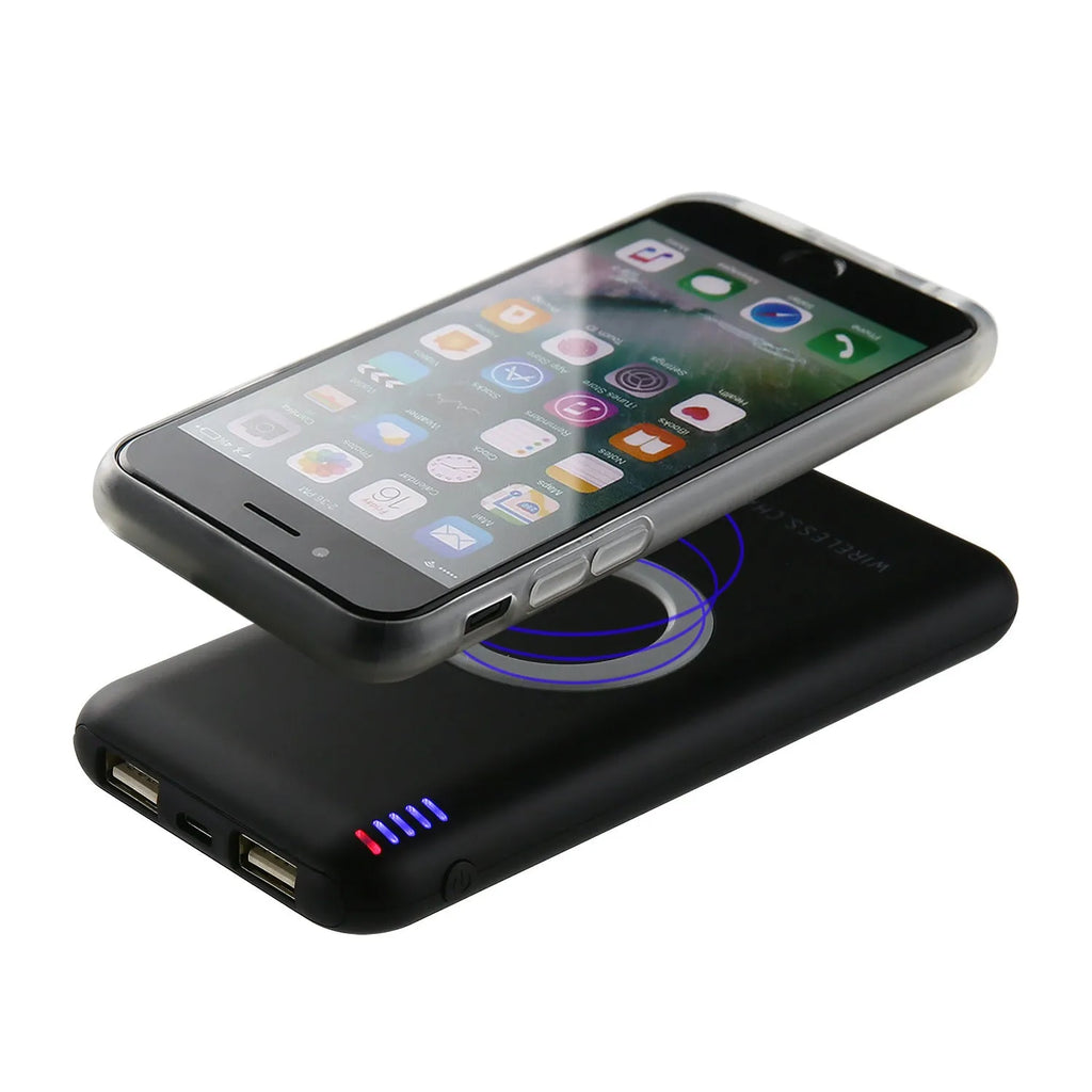 Black B100 wireless charging power bank on a wooden surface, showing USB port and charging indicator.