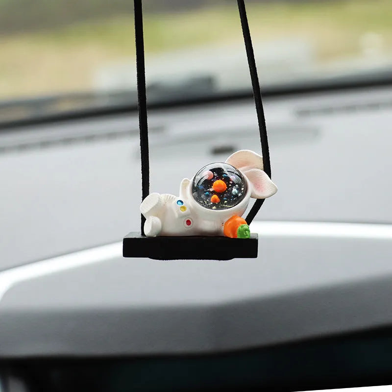 Resin cartoon astronaut car pendant hanging from a rear-view mirror.