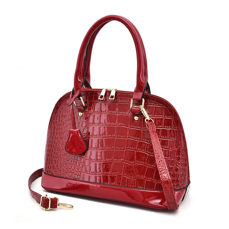 Large shiny crossbody shoulder bag with shell shape design showing 22x30x15cm dimensions