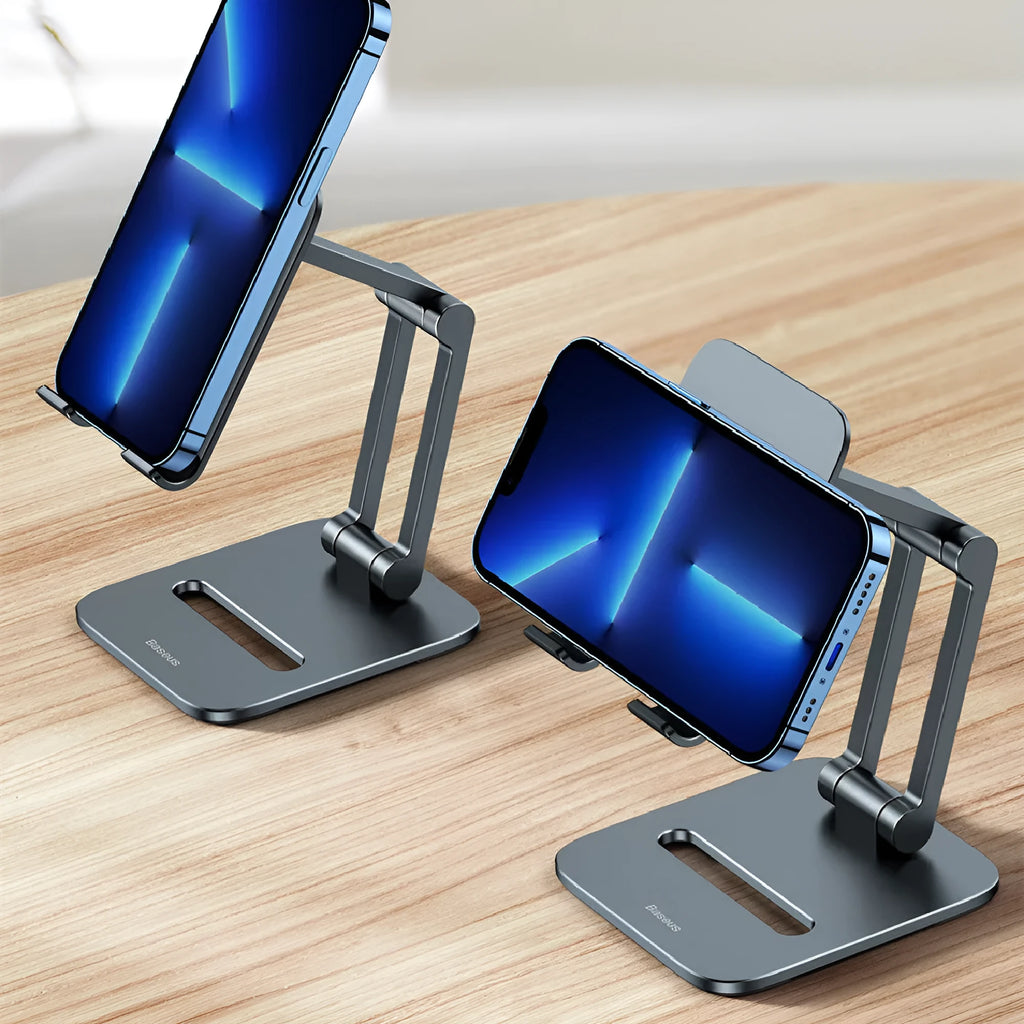 Deep space grey aluminium folding stand holding a tablet and a mobile phone on a desk.