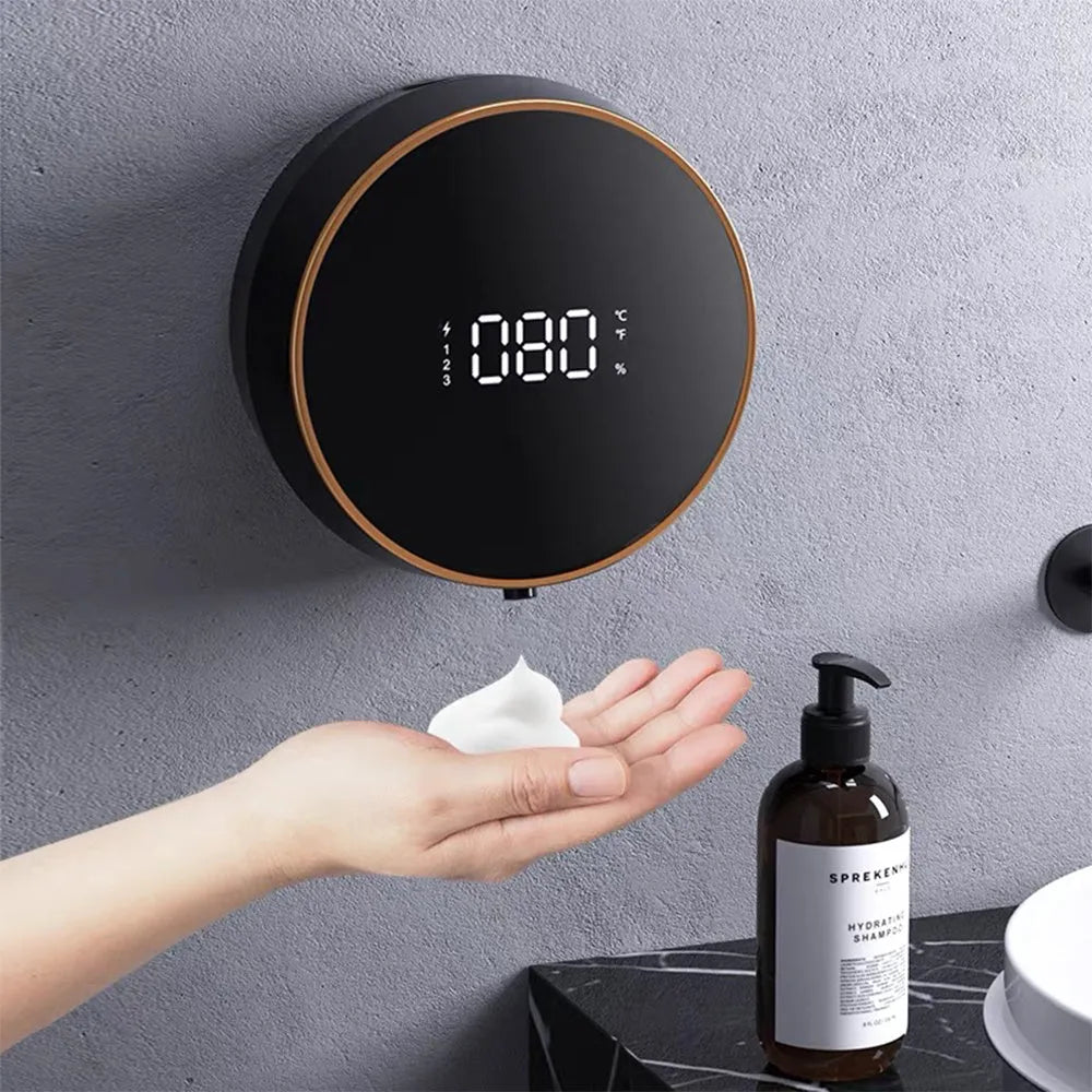 Black smart sensing foam dispenser mounted on wall with USB cable, showing sensor activation for touch-free hand cleaning