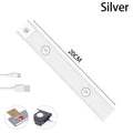 Ultra-thin USB LED night light with motion sensor in silver or black, showing magnet attachment for cabinets
