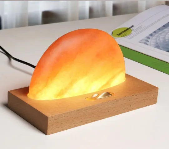 Wireless charging salt lamp with natural crystal salt shade on a solid beech wood base.