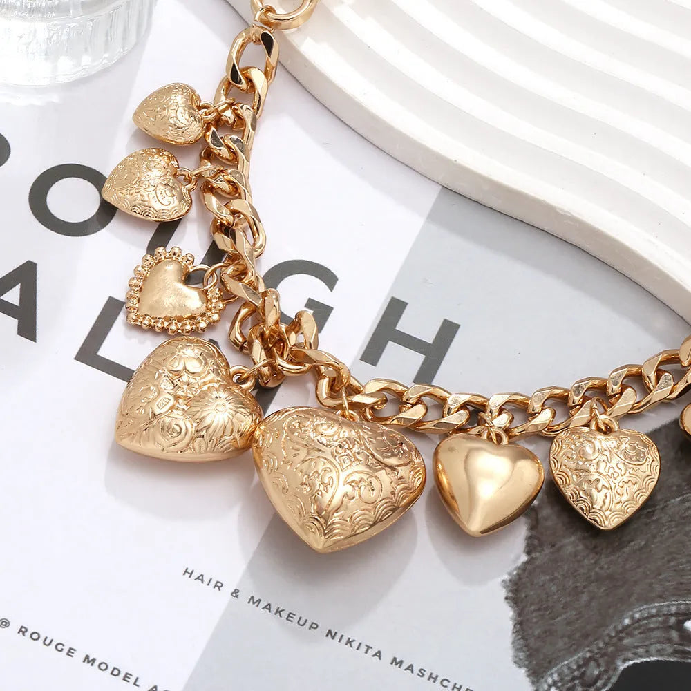 Gold heart pendant necklace with textured dripping oil finish on adjustable chain