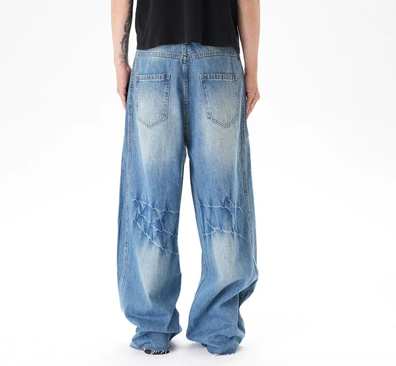 Light blue vintage washed wide leg denim jeans with a zipper fly on a mannequin.