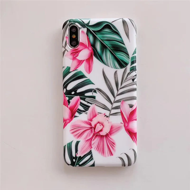 Pink flower design TPU phone case for iPhone on a table.