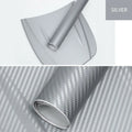 Roll of black carbon fibre textured vinyl sticker for car decoration, showing 3D pattern.