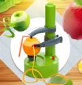 White electric apple peeler machine with stainless steel blade on kitchen worktop