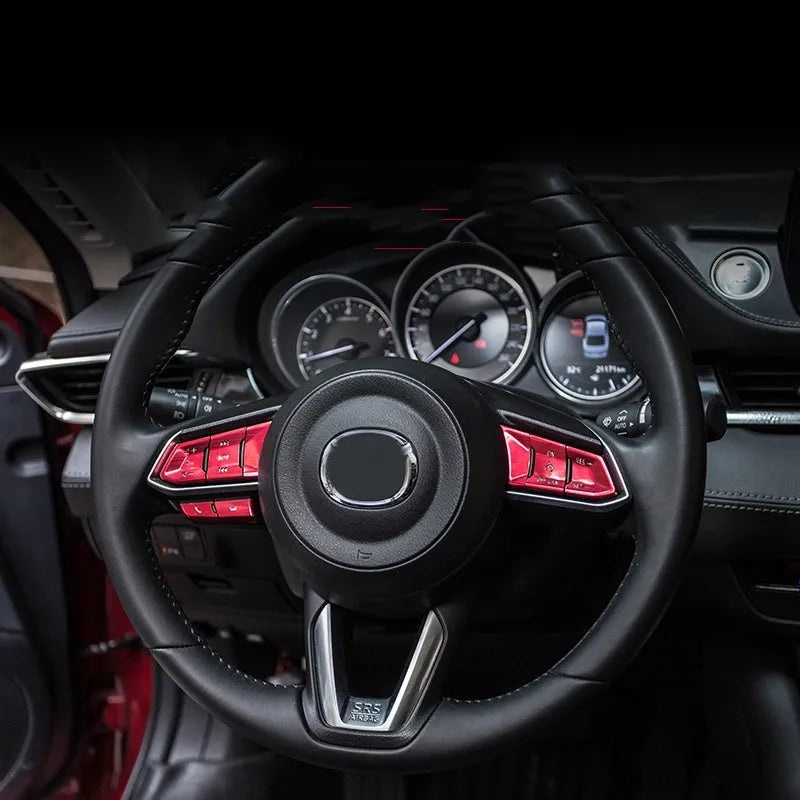 Set of eight aluminium alloy steering wheel button stickers in brushed red, silver, and blue finishes