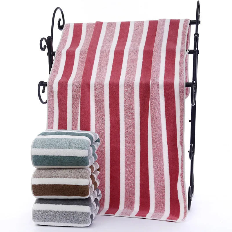 Coral fleece striped bath towel set showing hand towel and bath towel in grey and pink.
