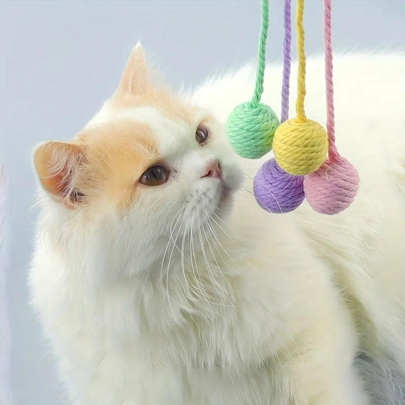 Colourful cat toy ball with attached rope and internal bell mechanism in green, pink, purple, or yellow options