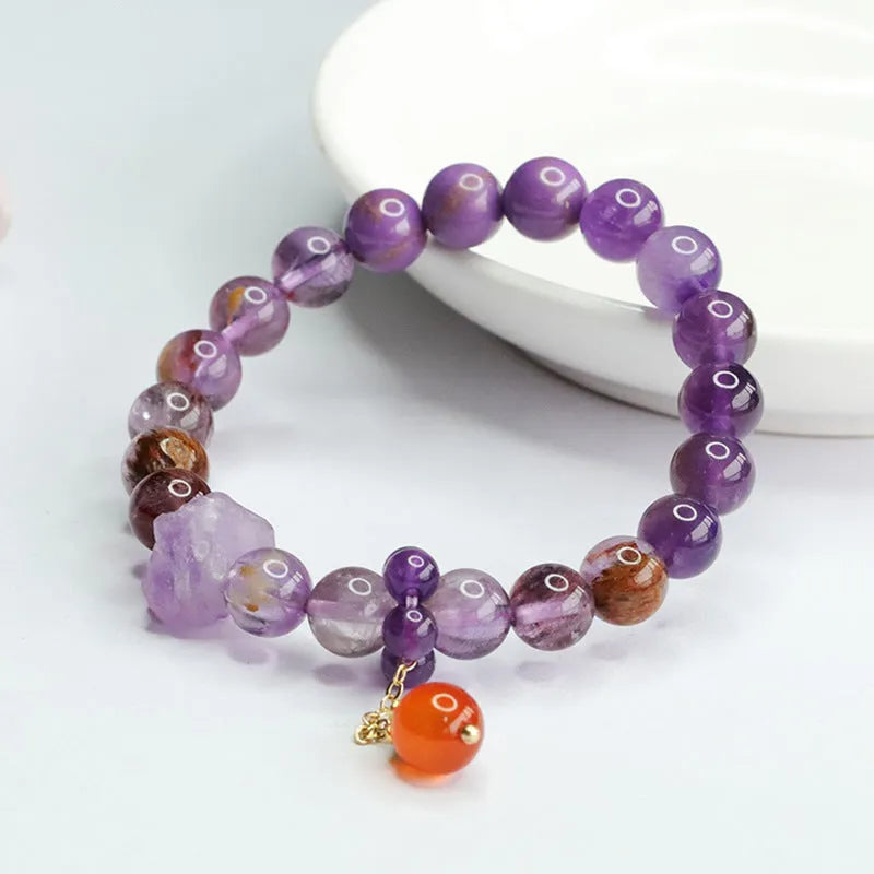 Adjustable nine purple amethyst and red agate Mori-style crystal bracelet showing 8mm beads and organic stone arrangement