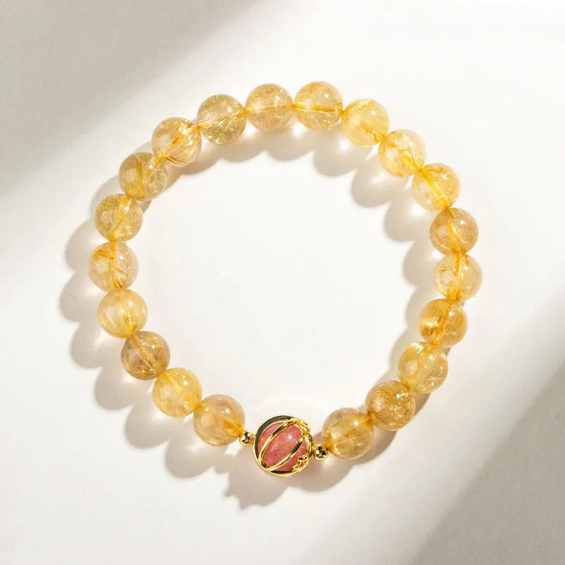 Gold rutilated quartz crystal bracelet with diamond-cut beads on stretch cord in Korean style