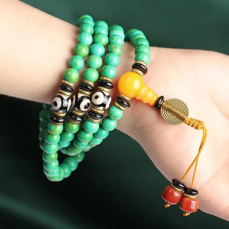 Natural turquoise gemstone bracelet with 108 round polished beads on a string.