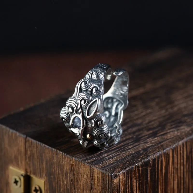 Adjustable open-style sterling silver ring with Jibeast zodiac pattern and diamond accents on finger