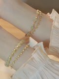 Natural Hetian Jade beaded bracelet with princess running motif on a wrist.