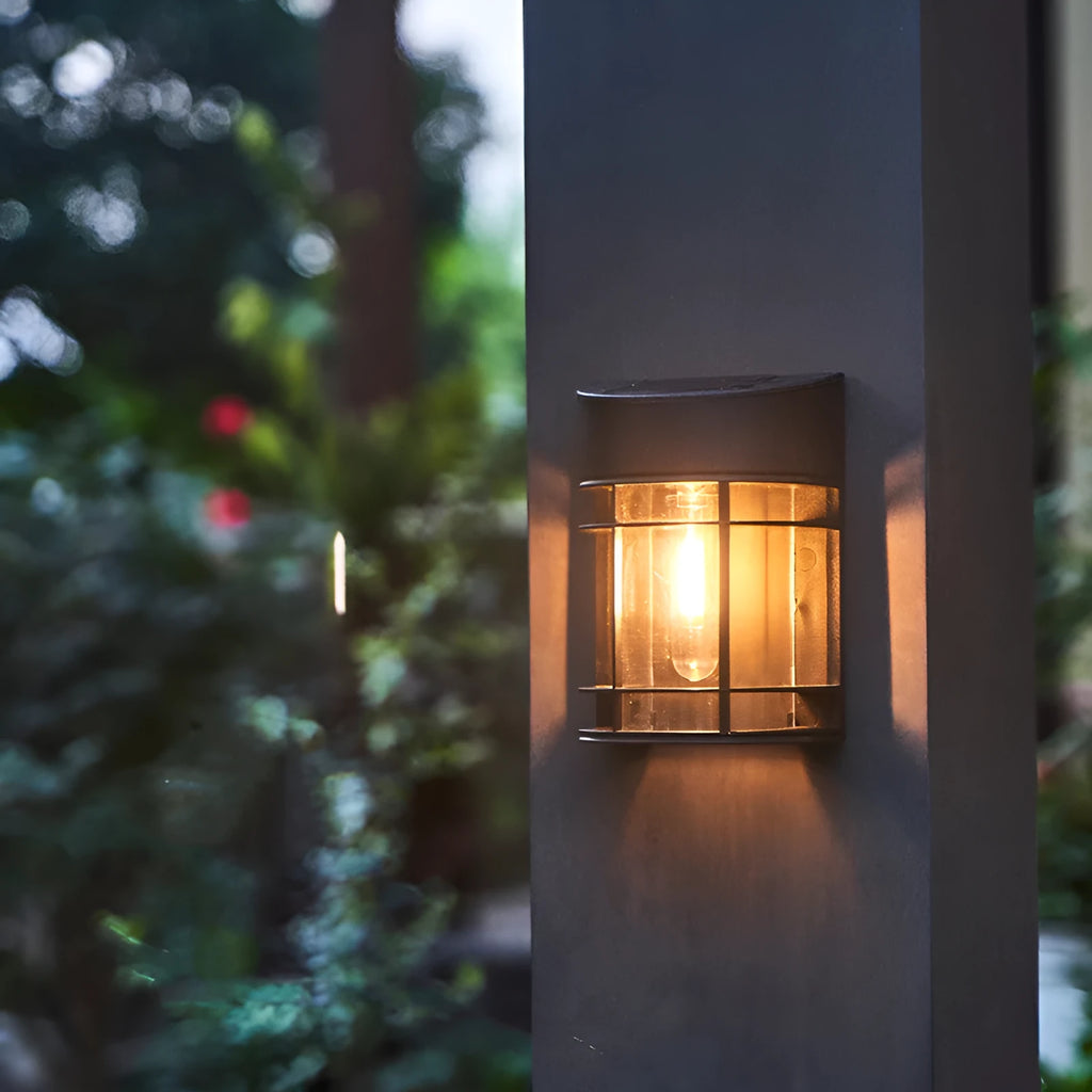 Tungsten-style solar-powered outdoor wall light with automatic light sensor mounted on a garden wall.
