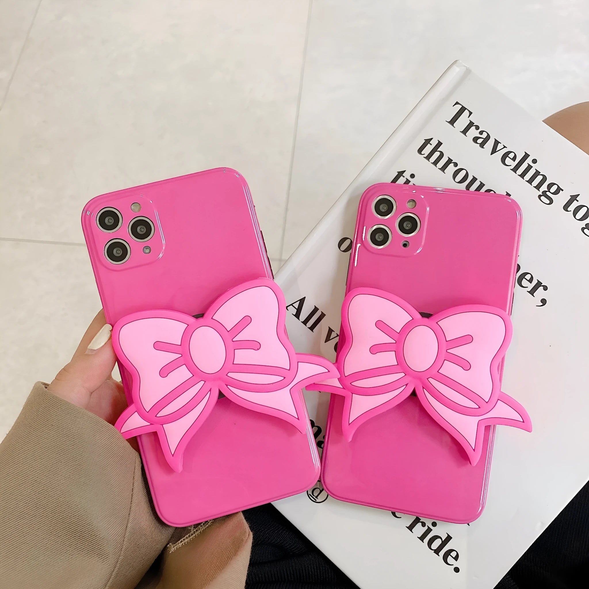 Rose Red iPhone case with pink bow design and a folded-out kickstand on the back.