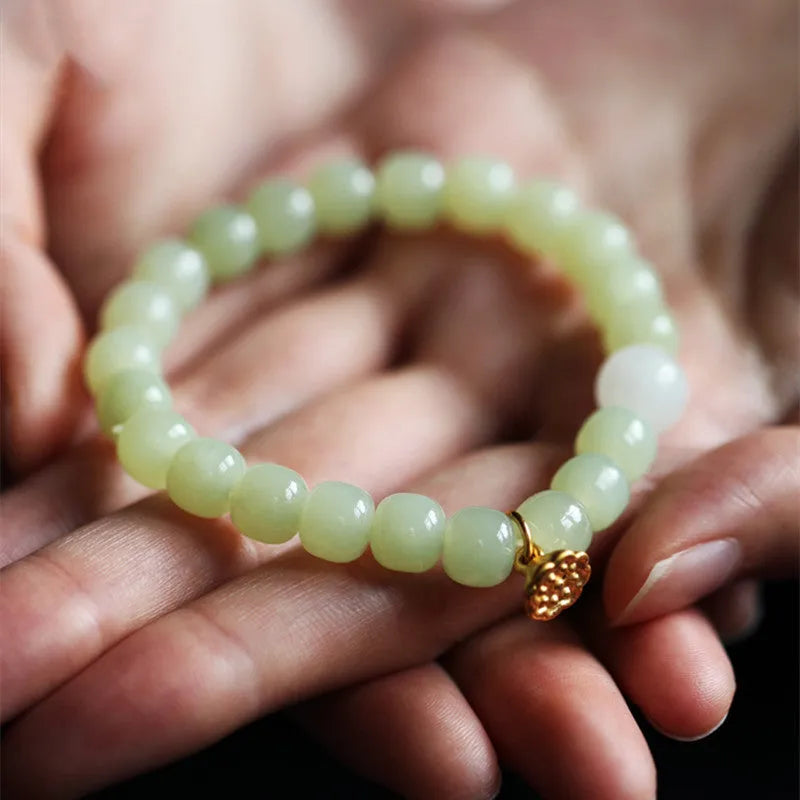 Green Hetian jade bracelet with vintage beads for women in an ethnic style.