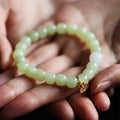 Green Hetian jade bracelet with vintage beads for women in an ethnic style.