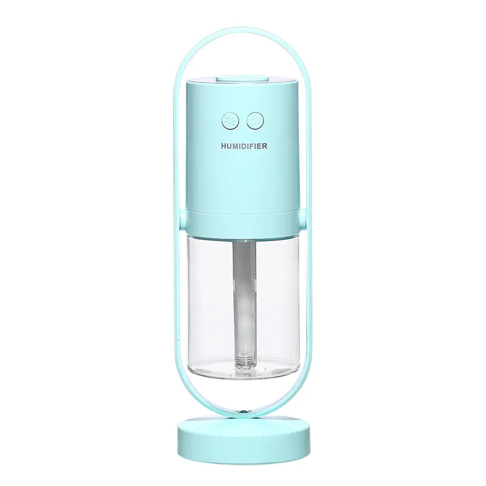 Pink USB portable air humidifier with projection night light on a wooden desk