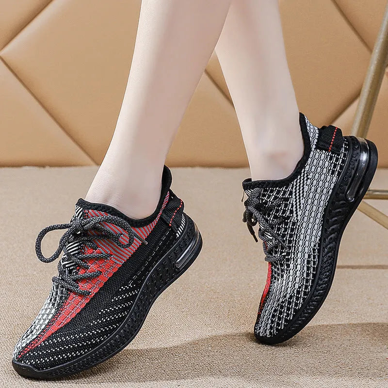 Women's low-top running shoes in purple, featuring a rounded toe and front lace-up design.