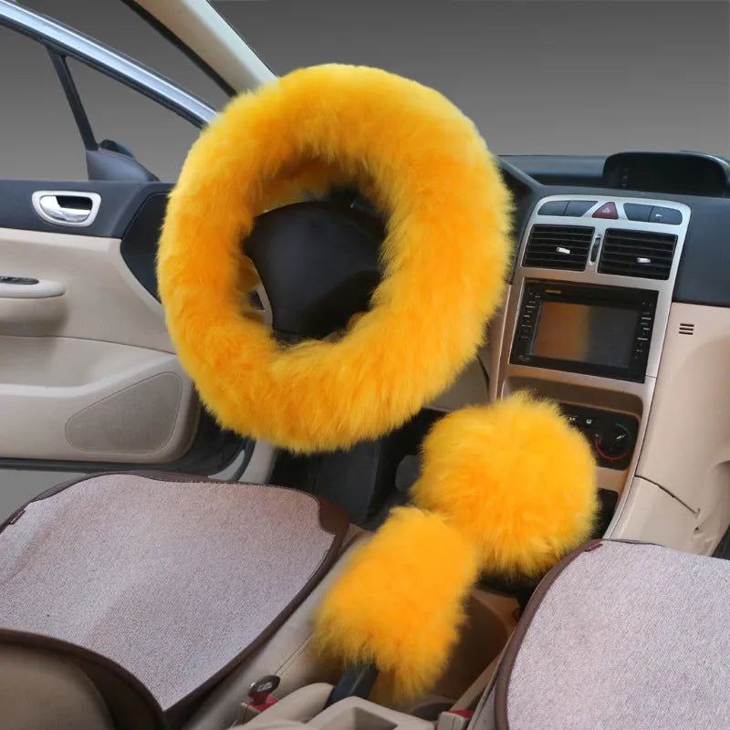 Wool and cashmere steering wheel cover and two long handle covers in a three-piece set on a car interior.