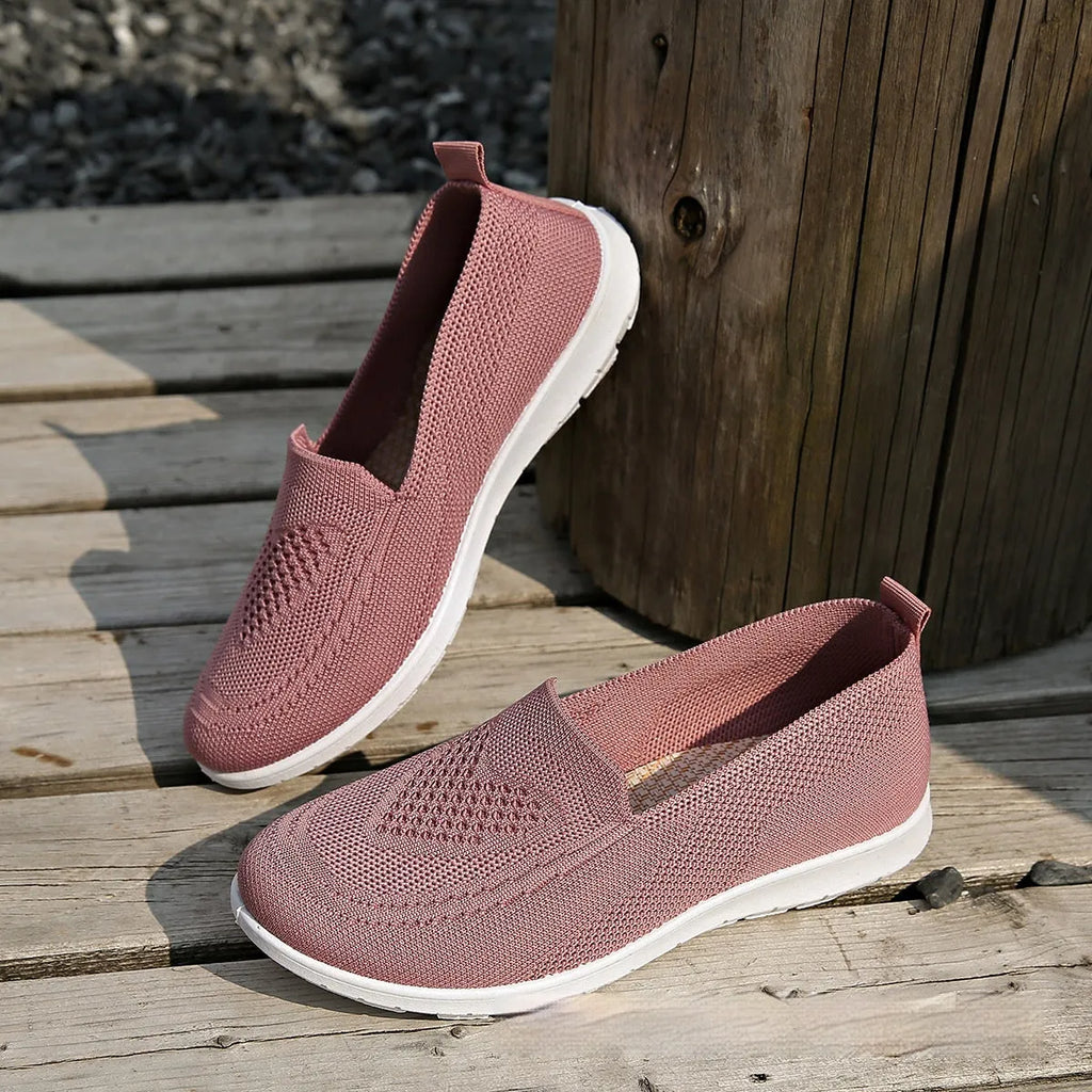 Women's plus size beige slip-on cloth shoes with low-cut design and flat sole.