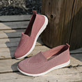 Women's plus size beige slip-on cloth shoes with low-cut design and flat sole.