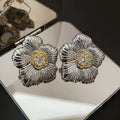 Retro gardenia stud earrings with textured floral design and two-tone electroplated finish