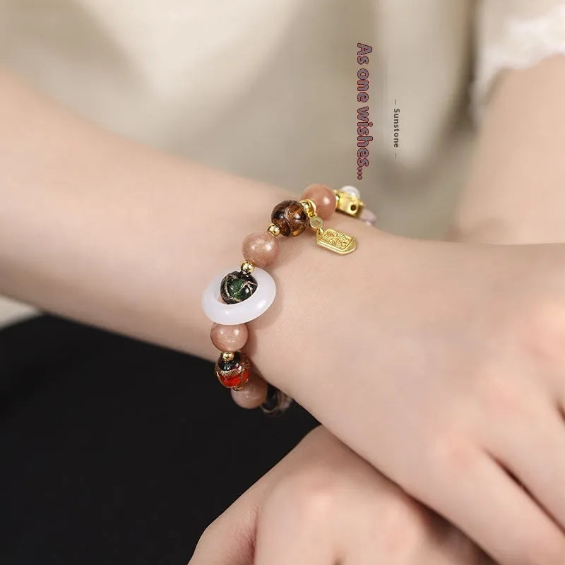 Hand-woven fragrant grey coloured glaze bracelet with round sunstone or white lip shell beads.